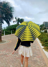 Load image into Gallery viewer, woman holding a lightweight, portable sun umbrella parasol to help her to block the sun's damaging UV rays that cause burning, premature aging and skin cancer.