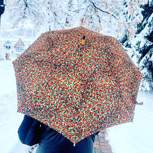 Load image into Gallery viewer, woman holding a lightweight, portable japarra sun umbrella parasol in Aspen to help her to block the sun's damaging UV rays that cause burning, premature aging and skin cancer.
