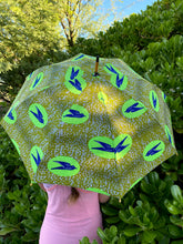 Load image into Gallery viewer, woman holding a lightweight, handheld japarra sun umbrella parasol to help her to block the sun's damaging UV rays that cause burning, premature aging and skin cancer.