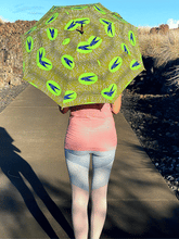 Load image into Gallery viewer, woman holding a lightweight, handheld japarra sun umbrella parasol to help her to block the sun's damaging UV rays that cause burning, premature aging and skin cancer.