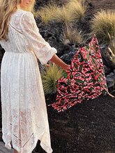 Load image into Gallery viewer, woman opening a lightweight, portable japarra sun umbrella parasol to help her to block the sun's damaging UV rays that cause burning, premature aging and skin cancer.