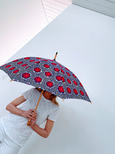 Load image into Gallery viewer, woman holding a lightweight, portable japarra sun umbrella parasol to help her to block the sun's damaging UV rays that cause burning, premature aging and skin cancer.