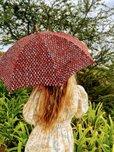 Load image into Gallery viewer, woman holding a lightweight, portable japarra sun umbrella parasol to help her to block the sun's damaging UV rays that cause burning, premature aging and skin cancer.