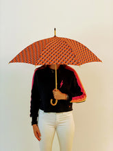 Load image into Gallery viewer, woman holding a lightweight, portable japarra sun umbrella parasol to block the sun's damaging UV rays that cause burning, premature aging and skin cancer.