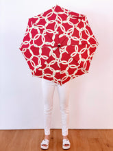 Load image into Gallery viewer, woman holding a lightweight, portable japarra sun umbrella parasol to help her to block the sun's damaging UV rays that cause burning, premature aging and skin cancer.