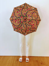 Load image into Gallery viewer, woman holding a lightweight, portable japarra sun umbrella parasol to help her to block the sun's damaging UV rays that cause burning, premature aging and skin cancer.