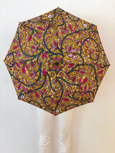 Load image into Gallery viewer, woman holding a lightweight, portable japarra sun umbrella parasol to help her to block the sun's damaging UV rays that cause burning, premature aging and skin cancer.