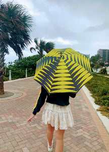 woman holding a lightweight, portable sun umbrella parasol to help her to block the sun's damaging UV rays that cause burning, premature aging and skin cancer.