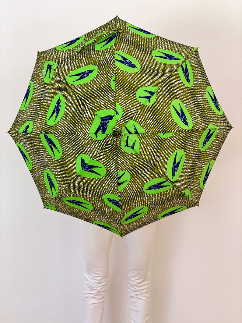 japarra sun umbrella parasol used to block the damaging UV rays from the sun that cause burning and aging. Lightweight, handheld green parasol sun umbrella.