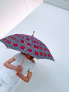 woman holding a lightweight, portable japarra sun umbrella parasol to help her to block the sun's damaging UV rays that cause burning, premature aging and skin cancer.